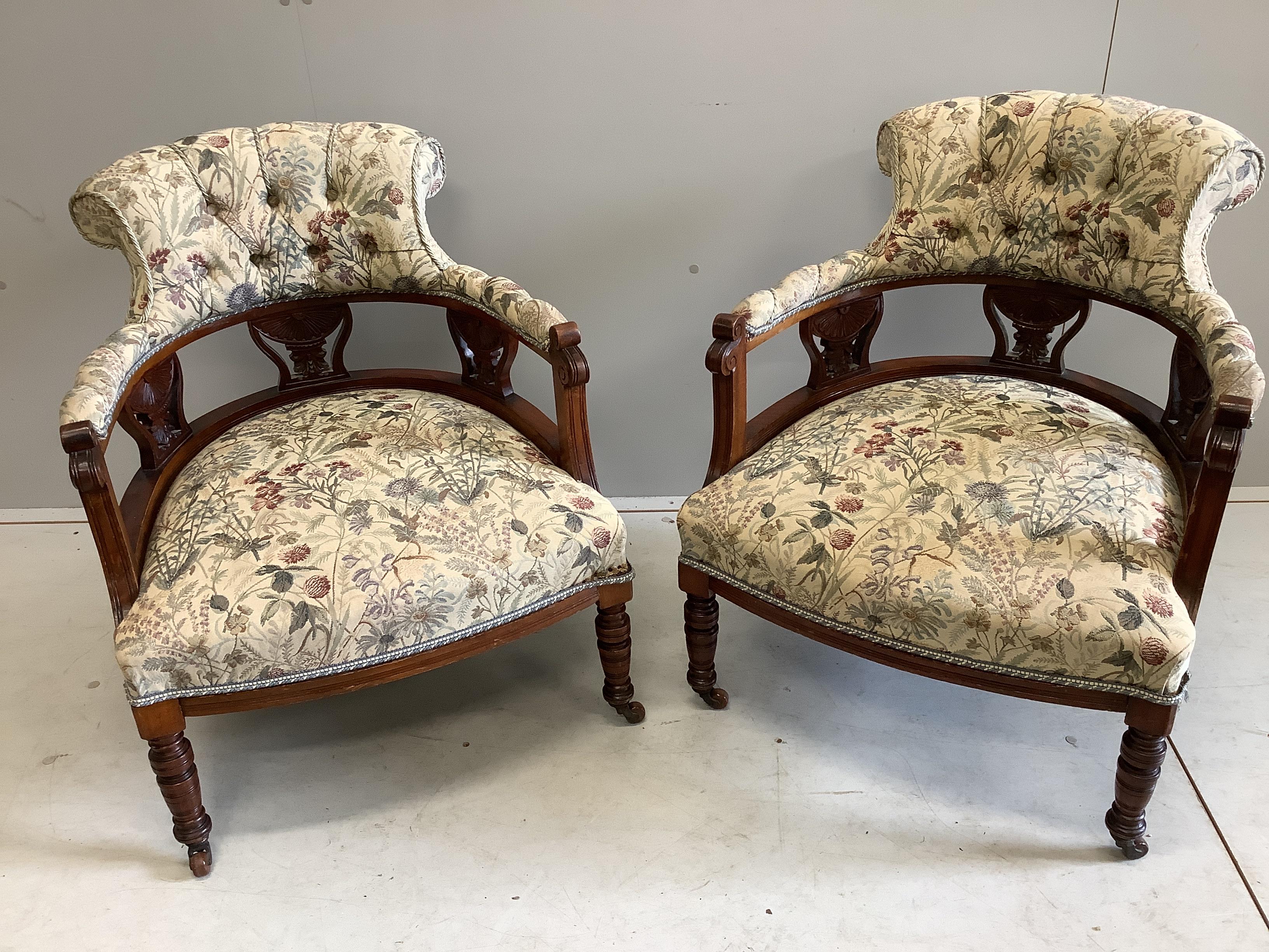 A pair of late Victorian mahogany upholstered tub framed salon chairs, width 61cm, depth 61cm, height 72cm